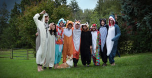Members of MistyWest wearing animal onesies at the annual retreat in 2019
